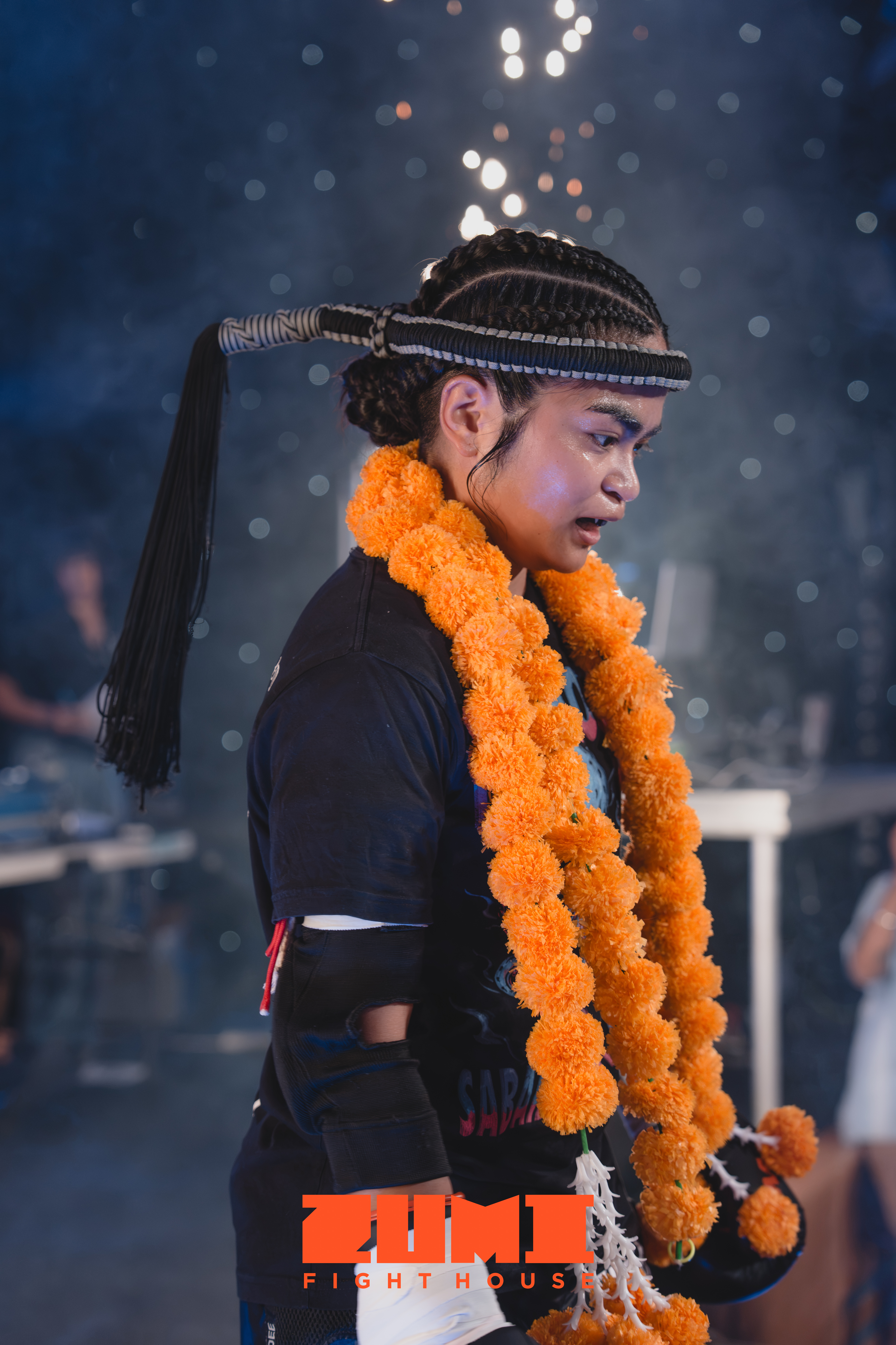Zumi Fight House Muay Thai fighter wearing traditional mongkol and marigold garland